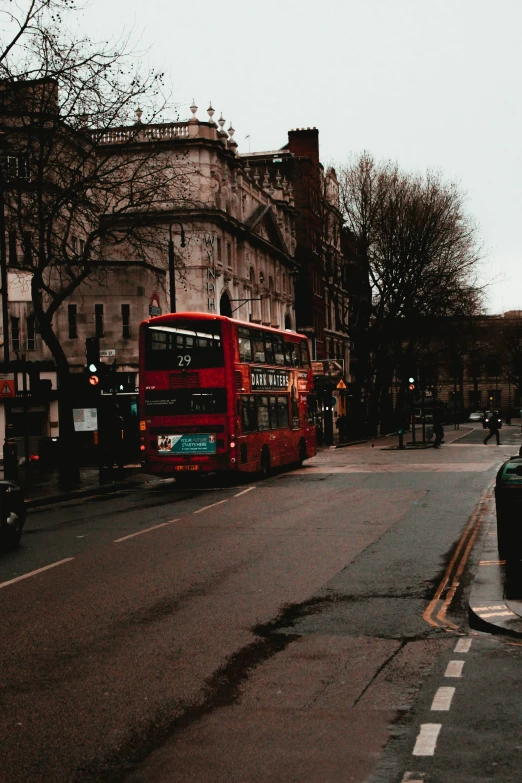 two double - decker buses pass each other on the street