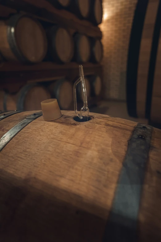 a glass sculpture sits atop a wooden barrel