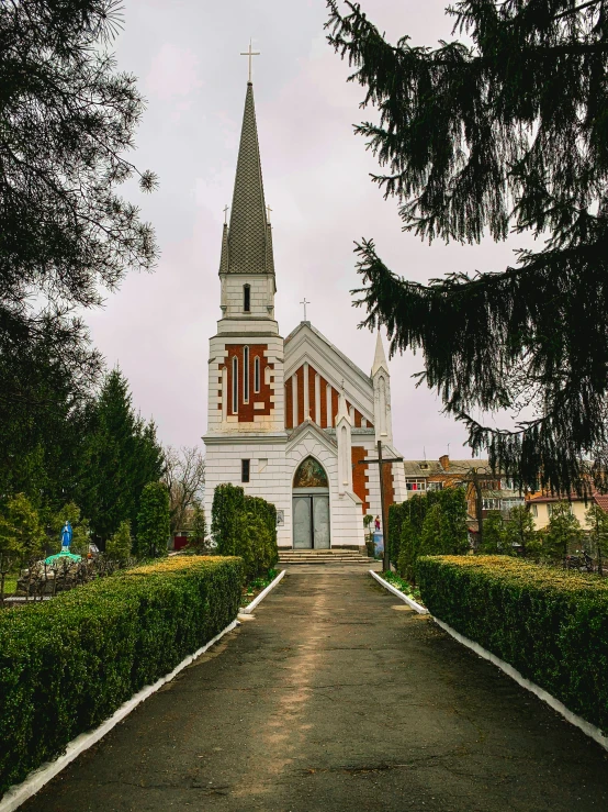 an exterior pograph of a church with trees in the foreground