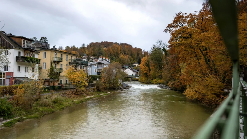 river moving through a neighborhood in the middle of a village