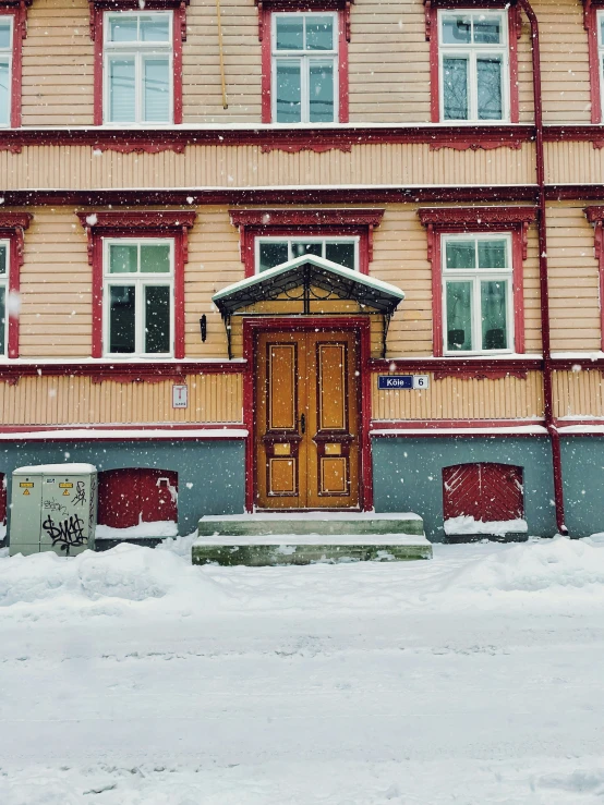 a building with snow on the ground in front of it