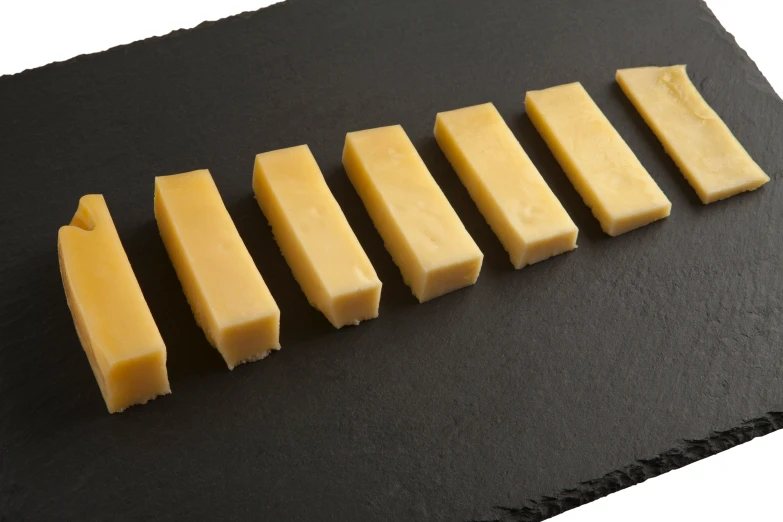 a number of different kinds of cheese on a plate