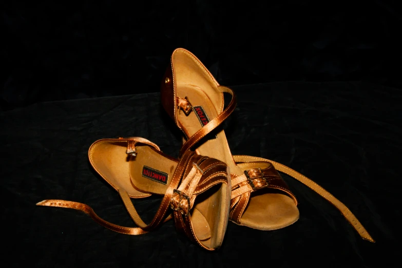 a pair of gold colored shoes with heels