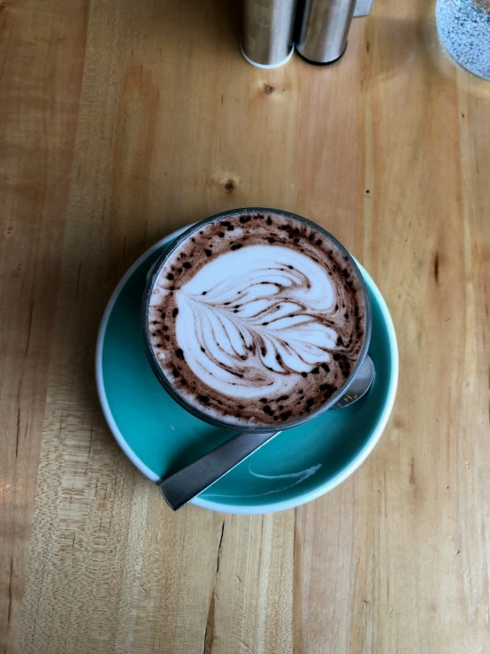 a close up of a plate with a cup of coffee