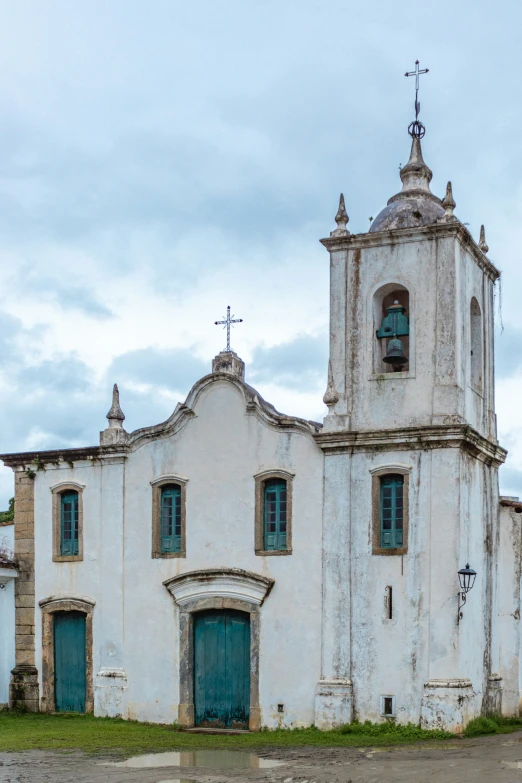 an old church with two clocks and four windows