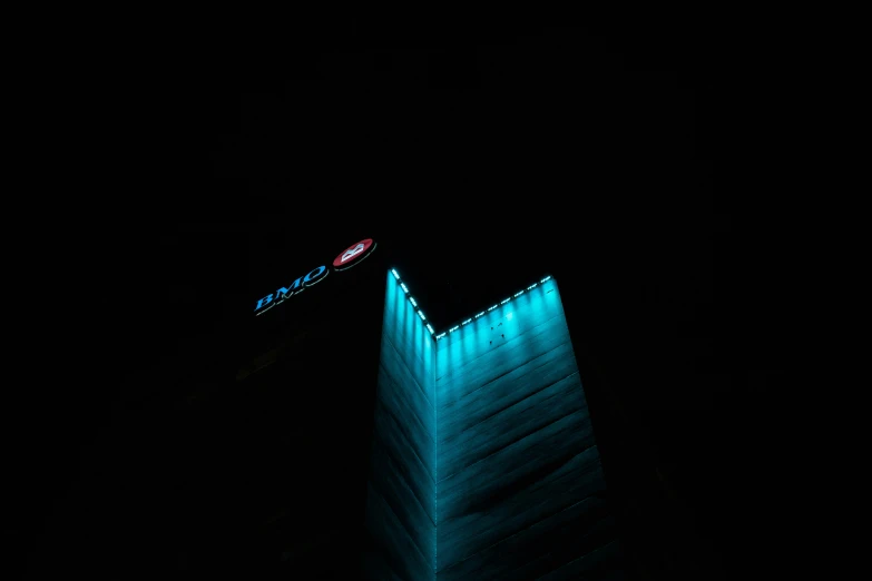 an airplane is flying past a building at night