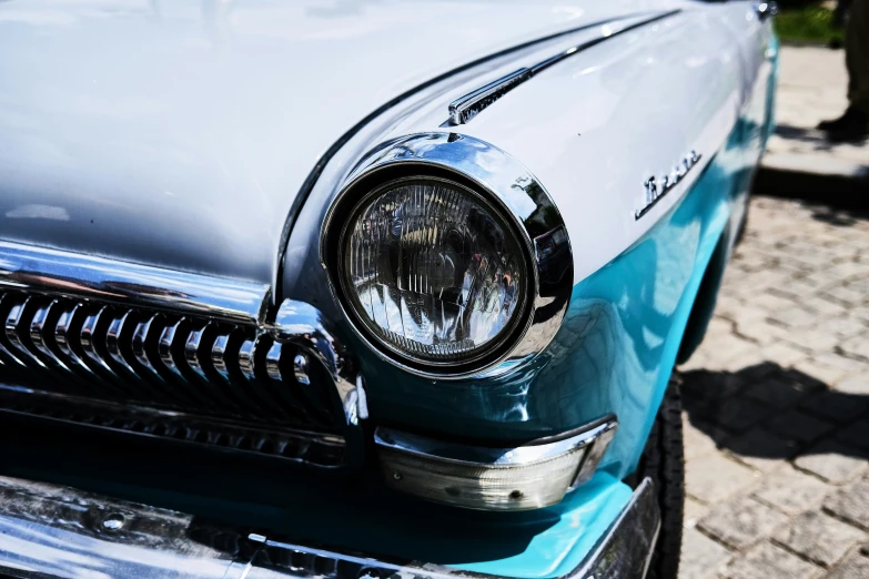 an old classic car sitting on the ground