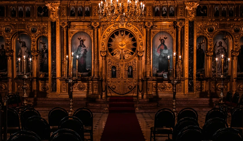an old church with gold, gilded walls and pews