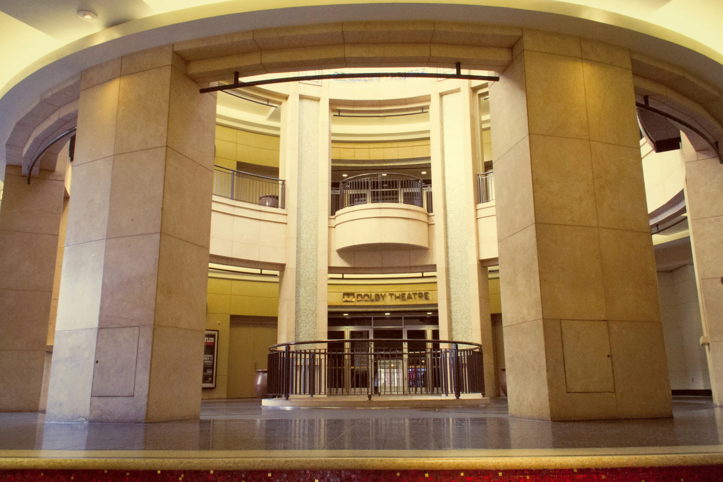 an atrium of a building with people standing around