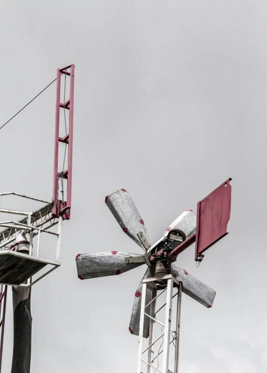 some kind of windmill with pink ribbons on it