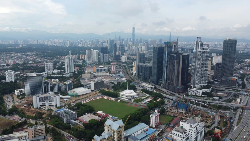 an aerial view of an urban area and large buildings in the distance