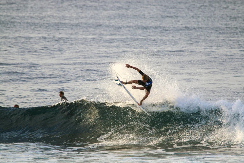 surfer riding breaking wave in ocean during daytime