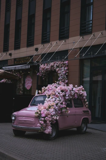 a car with flowers over the top and back of it