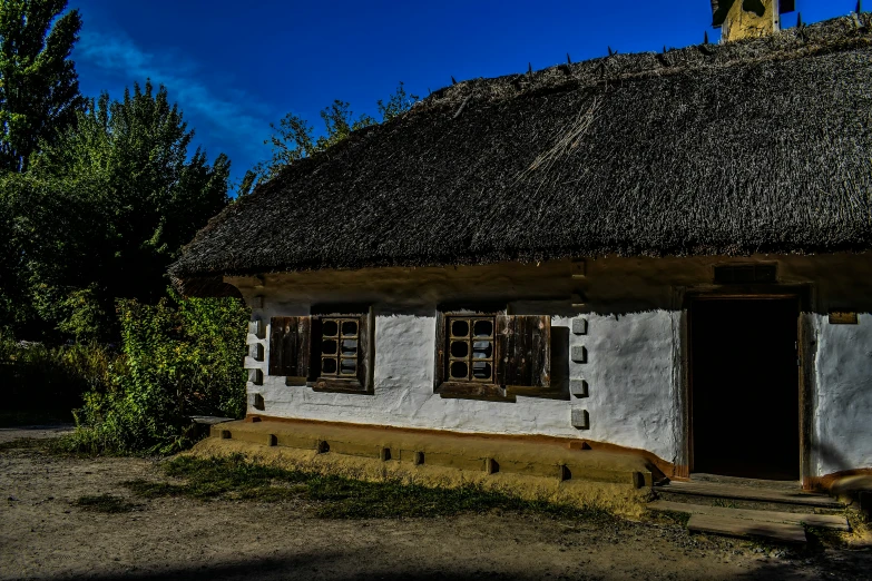 a very old and white building sitting under a blue sky