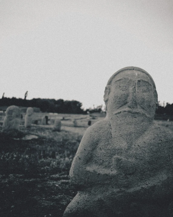 a statue is shown with an overcast sky behind it