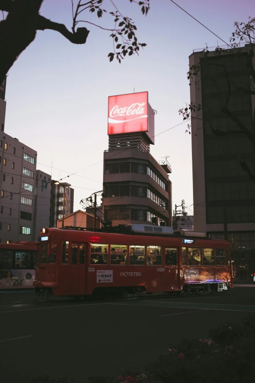 a red trolley is going down the street