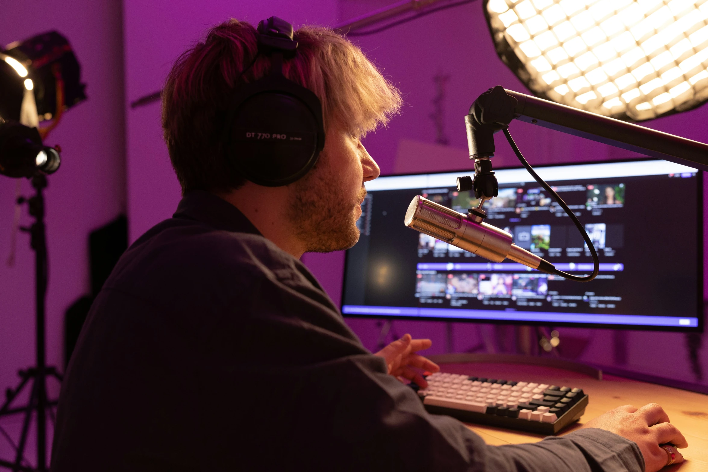 a man wearing headphones sitting at a desk