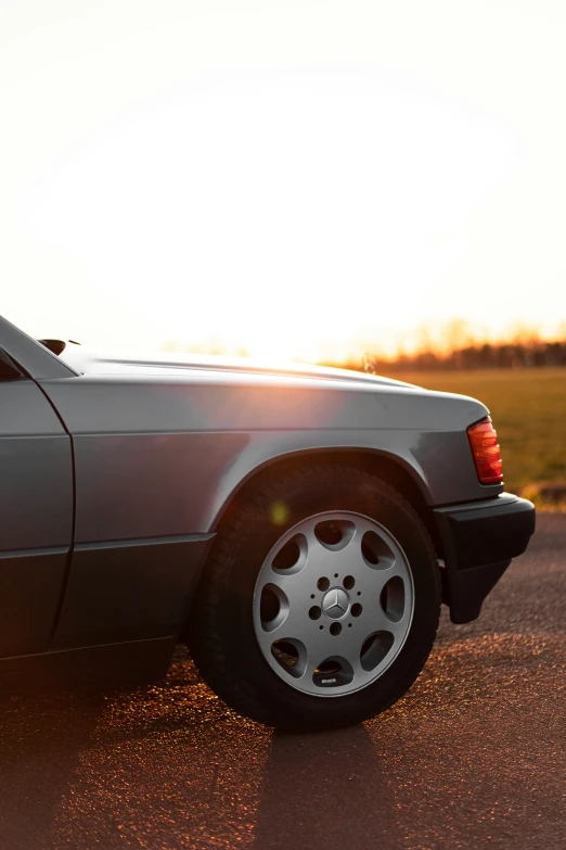 a car parked in the road at sunset