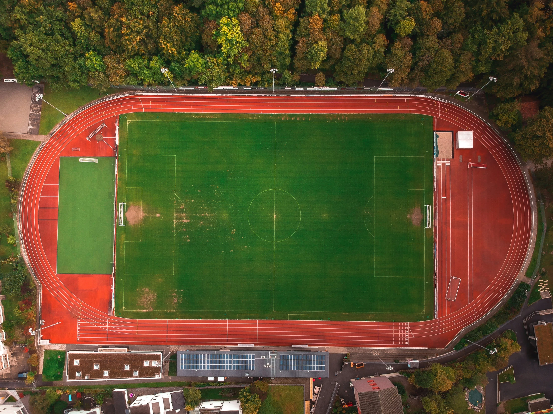 an aerial s shows a large field that sits in the middle of a city