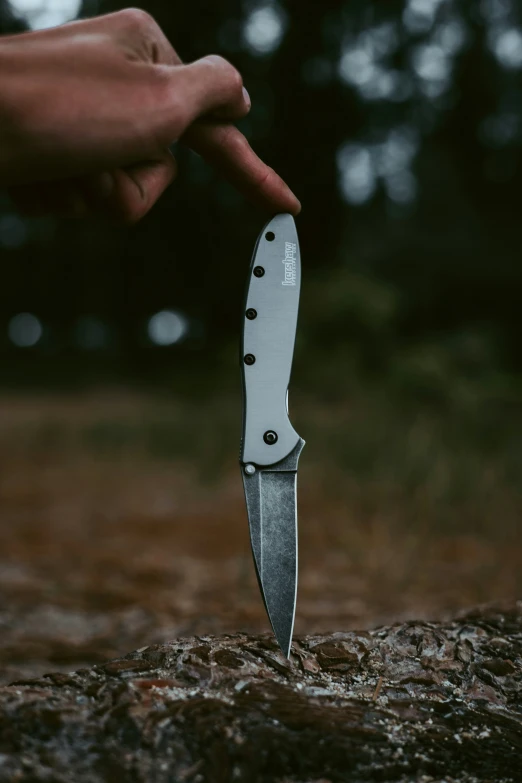 the man is pointing to the knife on the ground