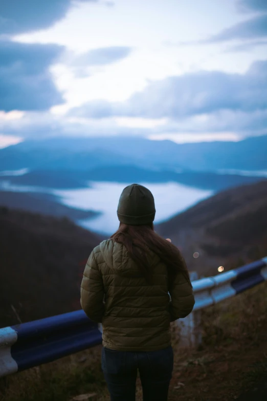 a person standing on a path in the mountains