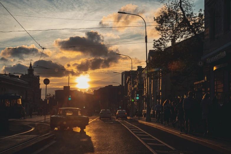 a po looking down the road at a cloudy sunset