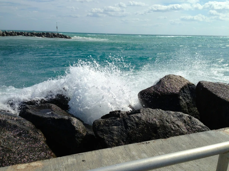 waves crash onto the rocks by the ocean