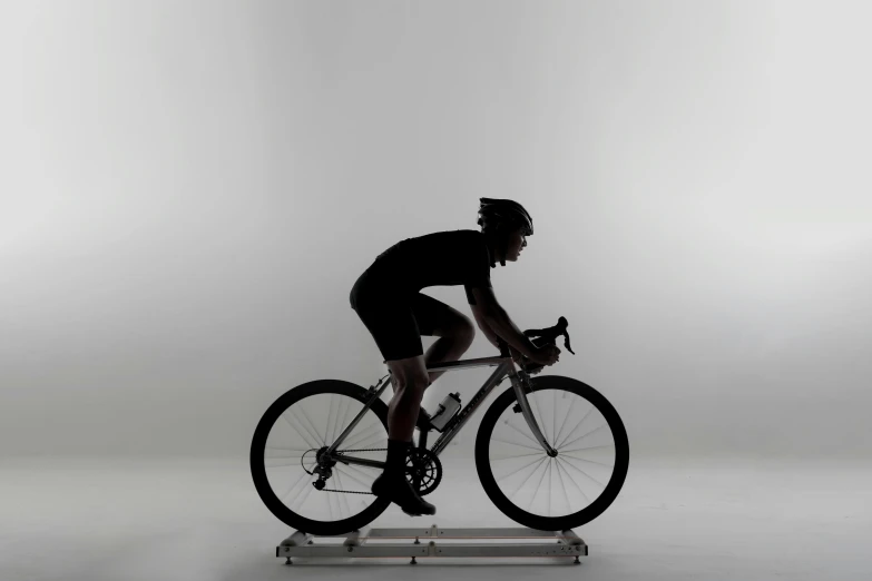 a woman riding a bicycle on a platform