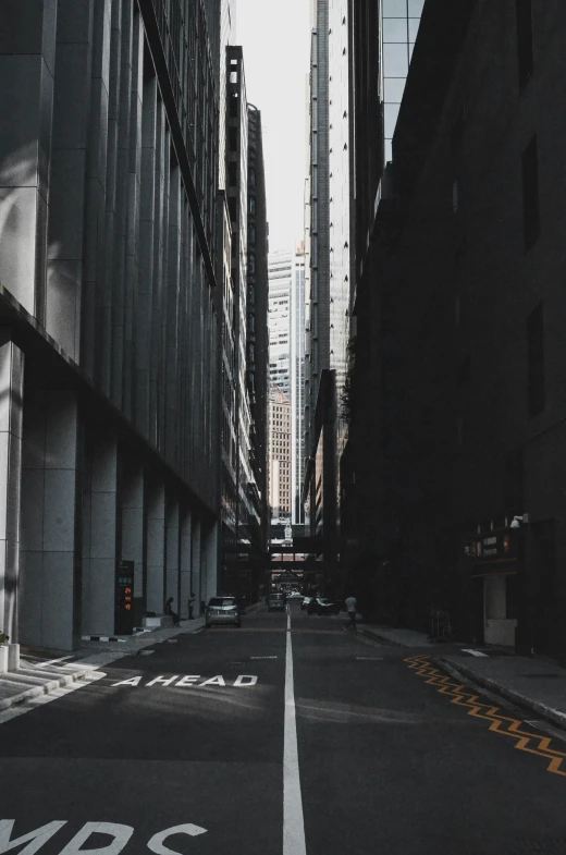 a wide empty street that is next to tall buildings