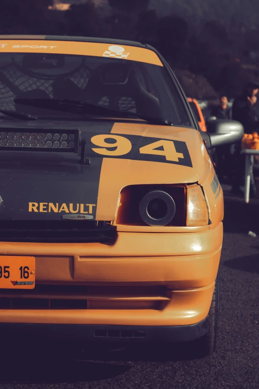 a sports car is parked in front of other cars