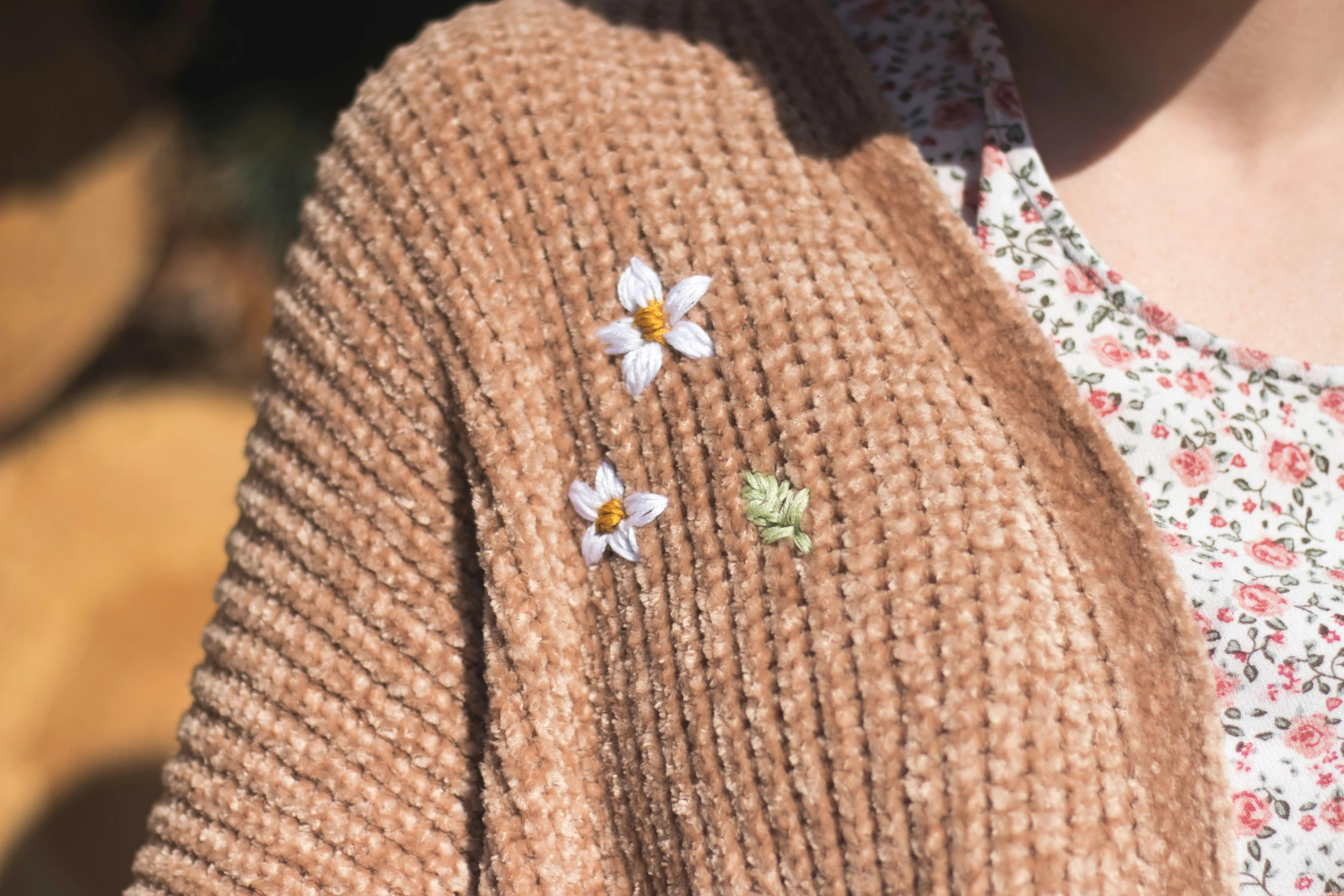 a woman's sweater with a pair of flowers on it