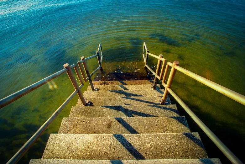 steps leading to the water from across a railing