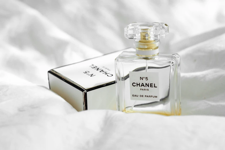 a bottle of chanel no 5 sitting on white fabric