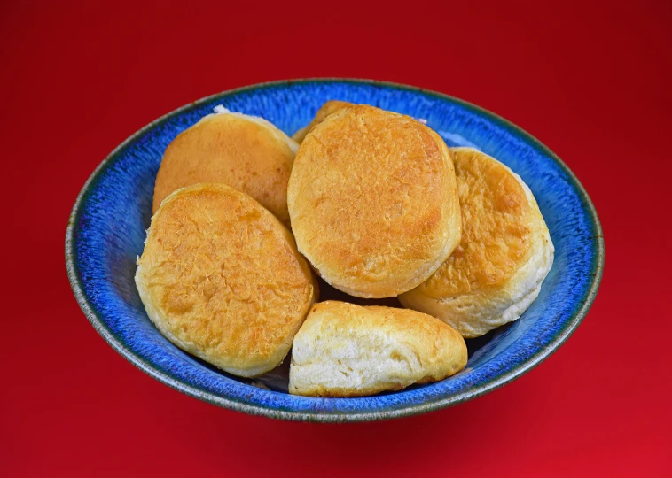 small, baked, , and ery buns on a blue plate