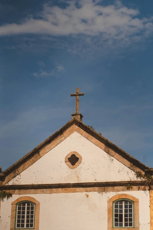 the cross is on top of an old church