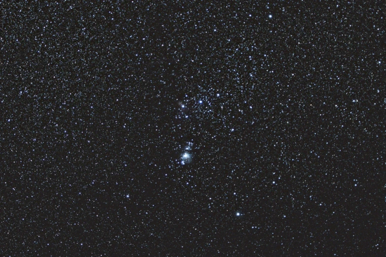 a bright star cluster with small stars in the dark night sky