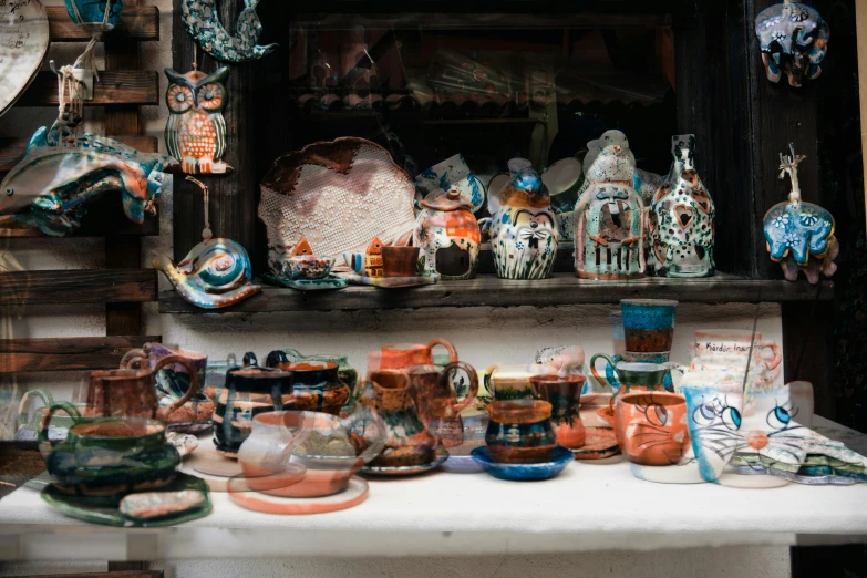 a table covered with dishes and ceramics