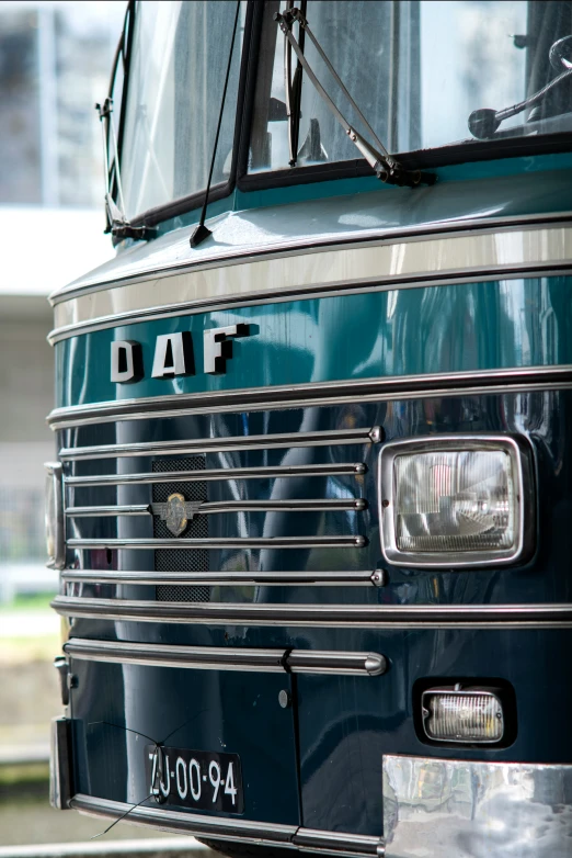 a dark blue bus sits in the parking lot