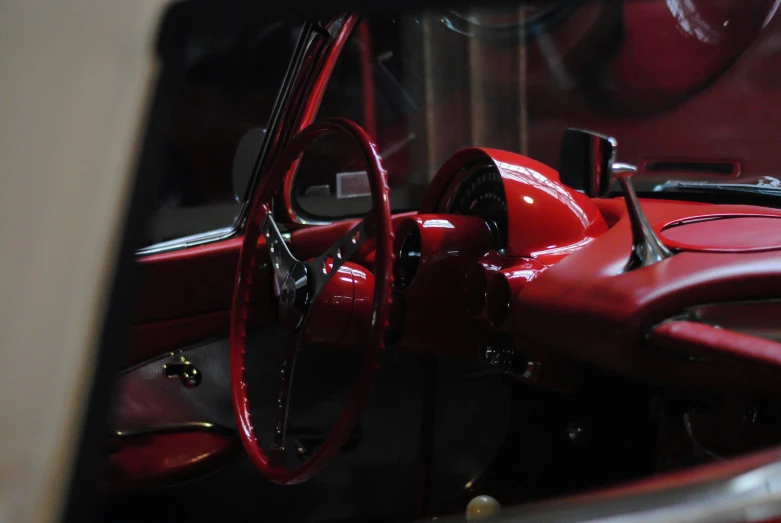 the inside view of a red vintage car with interior and dashboard