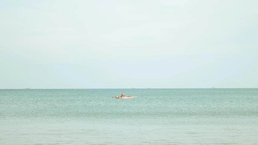 a man is out on a small boat in the ocean