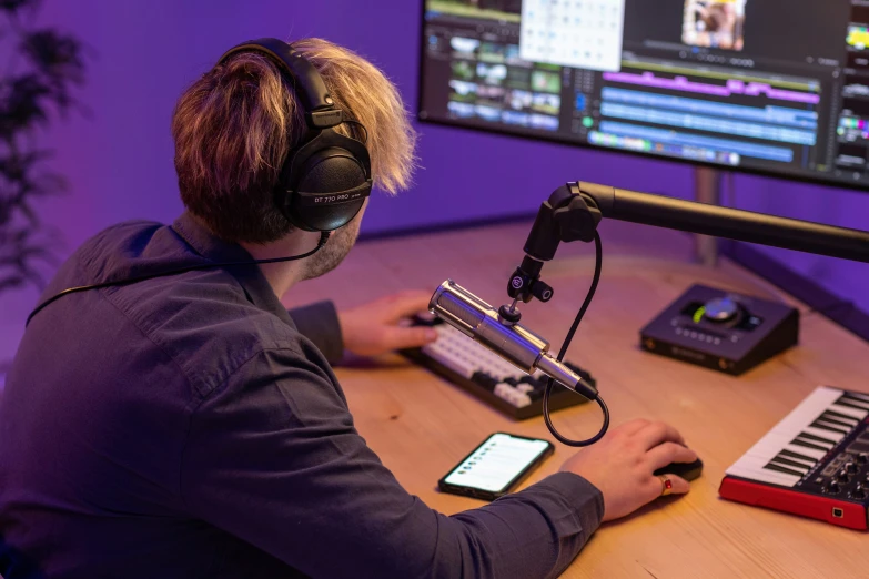 a person with headphones playing music on the computer