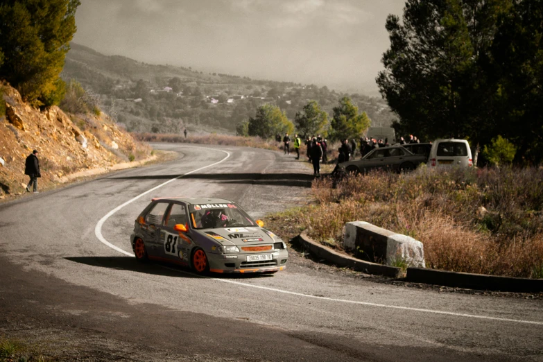 a rally car that is sitting on the side of a road