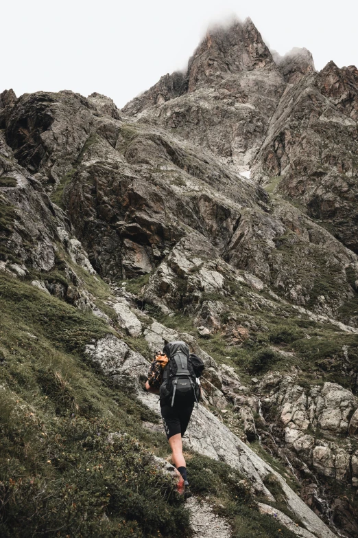 a person hiking up a trail in the mountains