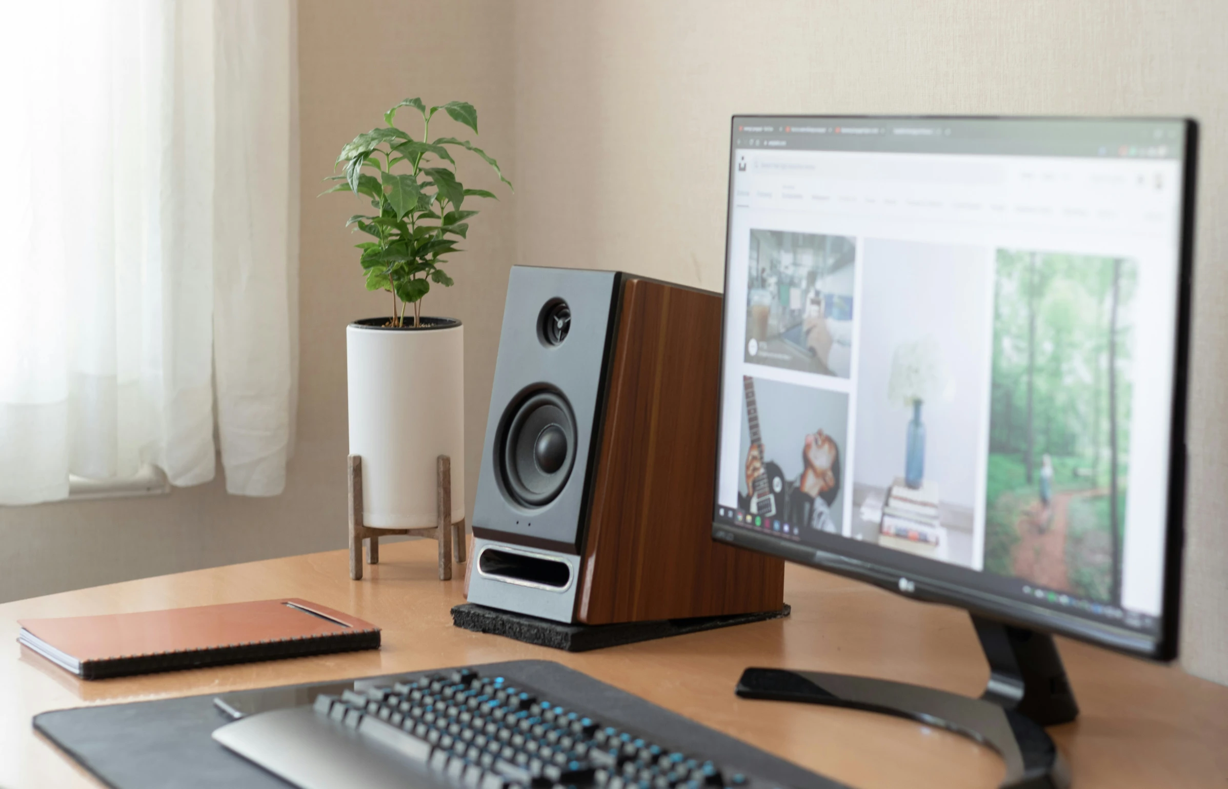 a desktop computer with a speaker, keyboard and monitor