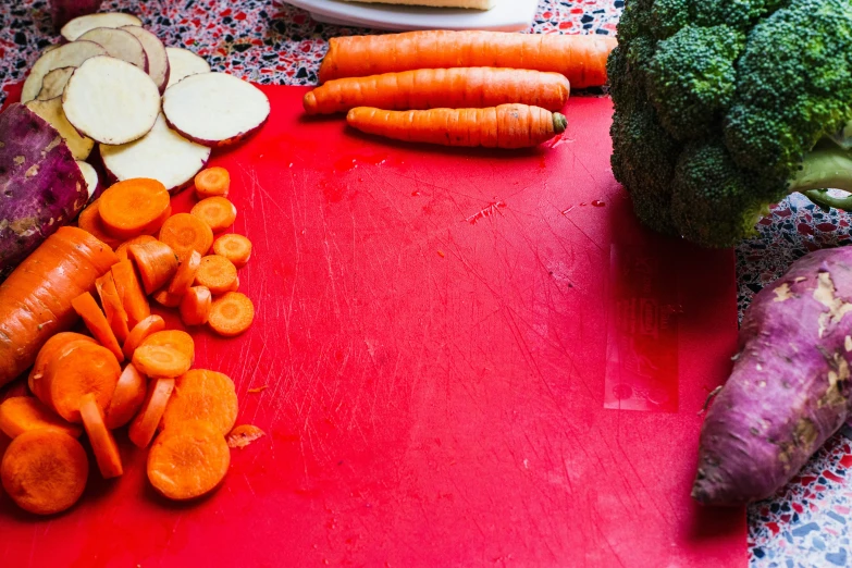 carrots and radishes are on a table next to other vegetables