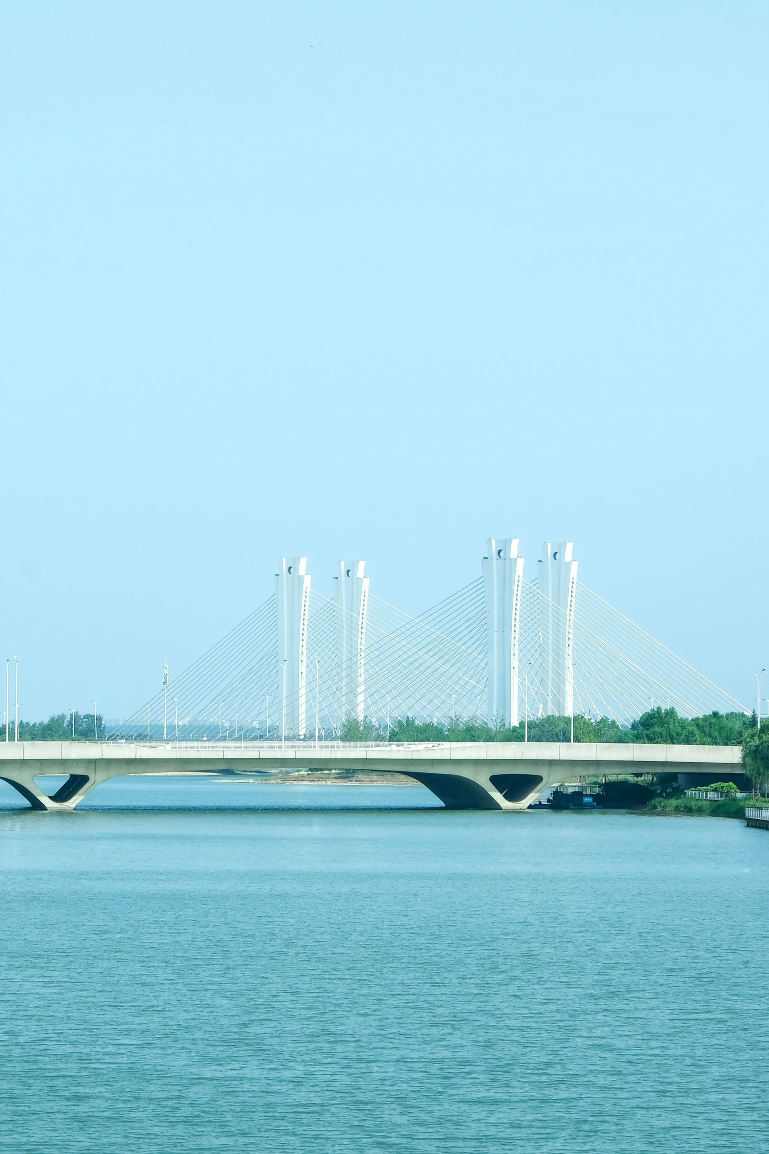 a bridge over a body of water with trees in the background