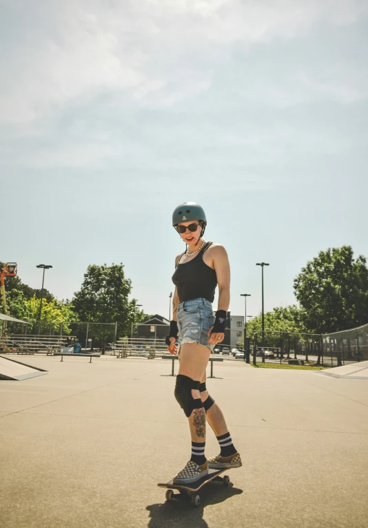 a female skateboarder is waiting on the edge of the course