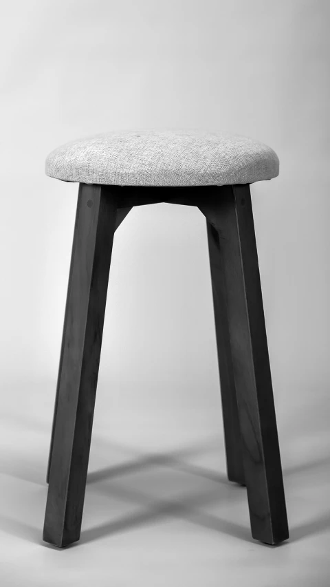 this is an image of a stool made from wood and fabric