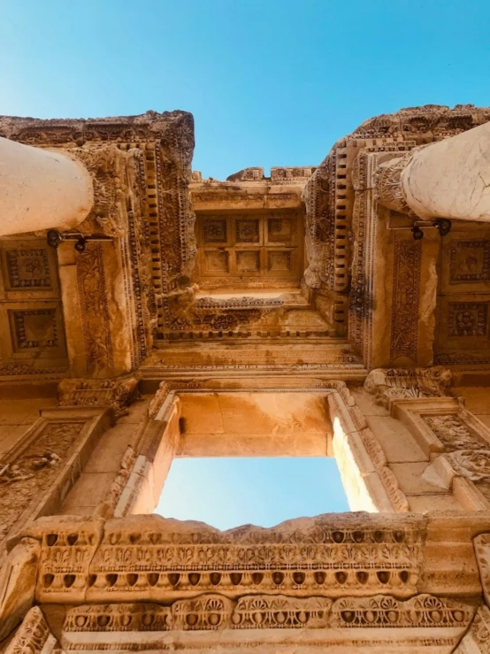 a group of ancient pillars stand against the blue sky