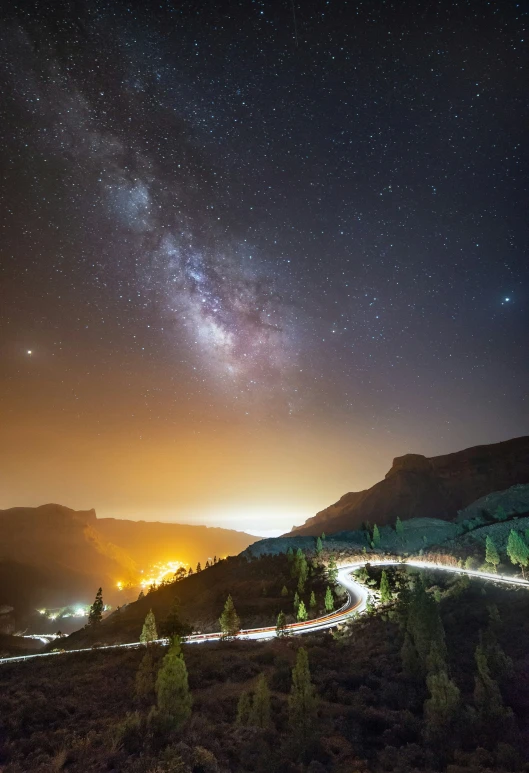 a night view of a street below the stars